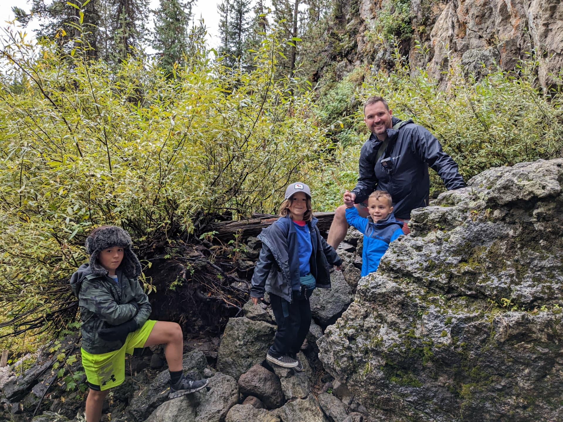 Leah's kids scrambling over rocks on a Yellowstone trail
